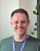 A male looking at the camera and smiling